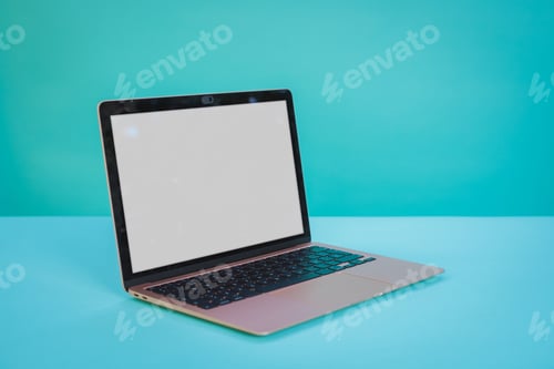 Preview: Laptop computer with blank screen on Aztec green paper background.