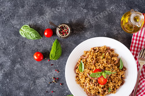 Preview: Israeli couscous with beef. Tasty food. Asian meal. Top view. Flat lay.