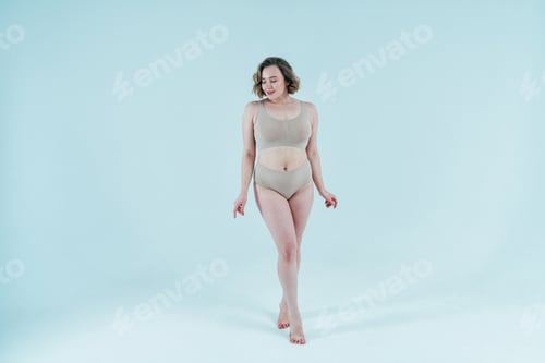 Preview: Image of a beautiful woman posing in studio wearing lingerie. Concept about body positivity