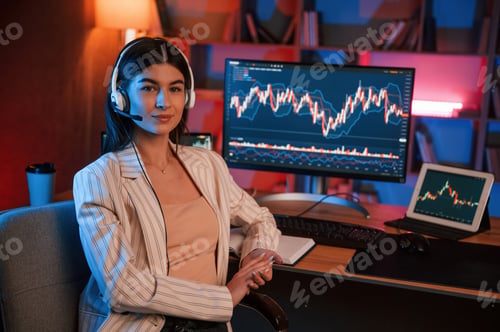 Preview: Female stock trader is working by pc indoors. Conception of exchange and money