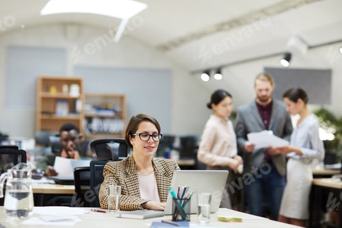 Preview: Smiling Businesswoman Working in Open Space Office