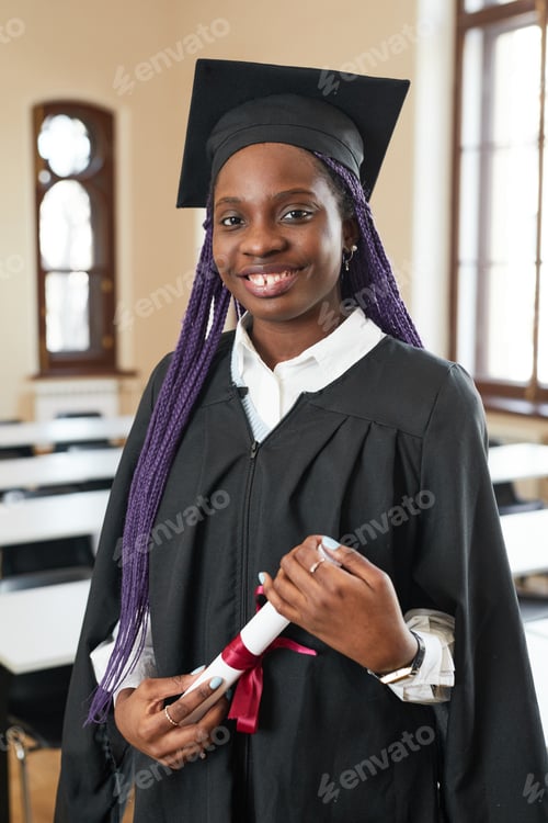 Preview: Smiling woman in graduation gown and cap