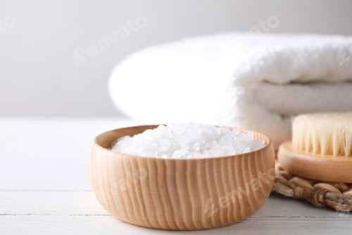 Preview: White sea salt for spa scrubbing procedure on wooden table