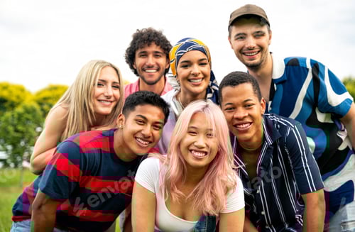 Preview: Group of multiethnic teenagers spending time outdoor on a picnic at the park