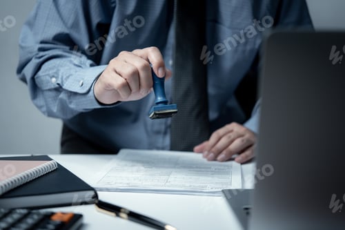 Preview: Businessman stamp rubber with approved stamp on document contract or paperwork lawyer.