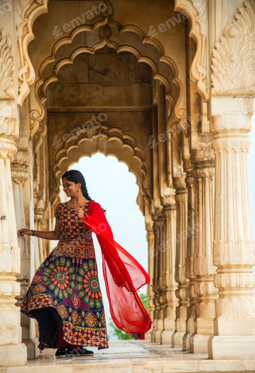 Preview: Young female tourist dancing between arches and Pillars.