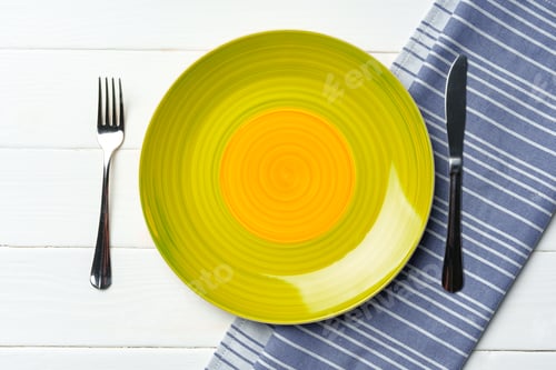 Preview: Top view of color ceramic plate on wooden background