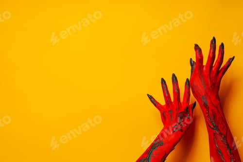 Preview: Creepy, red hands of a monster on a yellow background