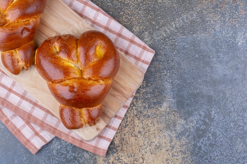 Preview: Heart-shaped buns on a board on marble background