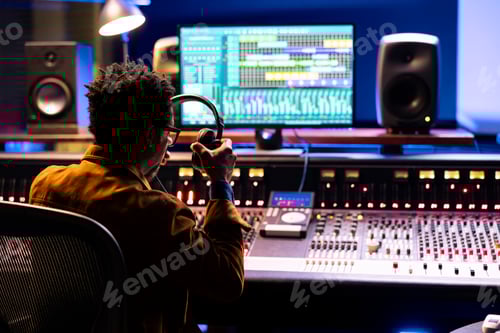 Preview: Audio expert leveling sound on a mixer control panel board