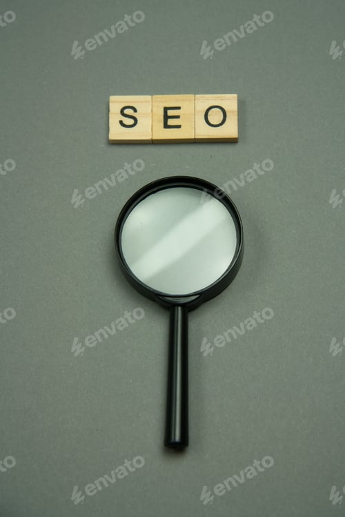Preview: SEO written in wooden letters and magnifying glass.