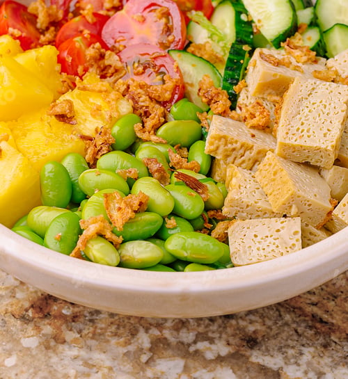 Preview: Colorful salad bowl featuring fresh vegetables and tofu on a marble table