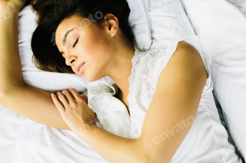 Preview: Above view of pretty woman in bed