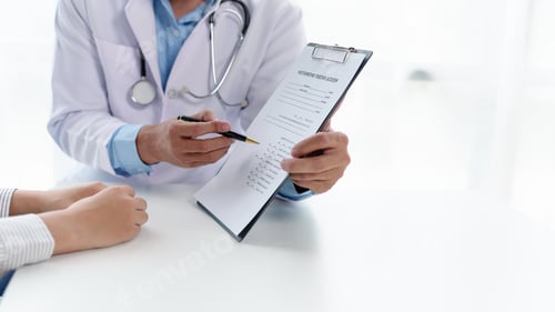 Preview: Doctor Consulting with Patient, Examines Medical Information