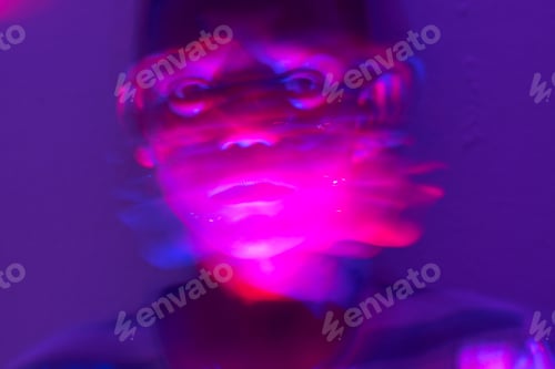Preview: Blurred motion of young boy in room filled with colorful light