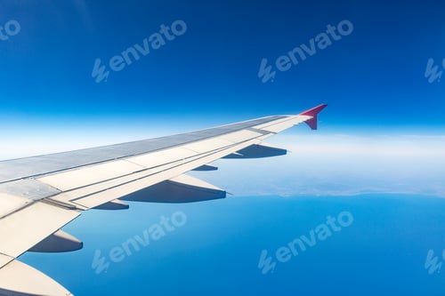 Preview: Wing of an airplane. Traveling concept. Aircraft wing on the clouds