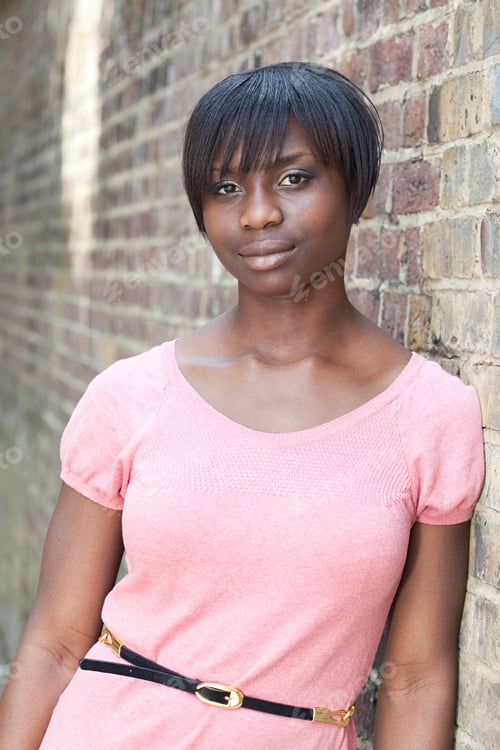Preview: Portrait of young woman by wall