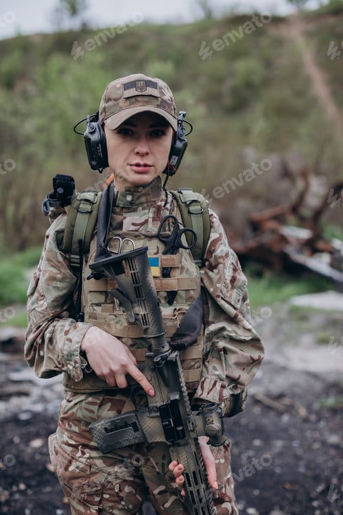 Preview: Woman in Camouflage Gear Holding a Rifle
