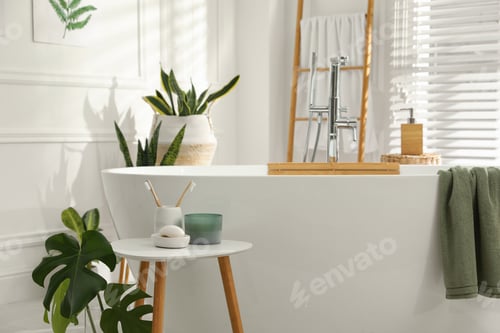 Preview: Toothbrushes and soap on table near bathtub indoors. Interior design