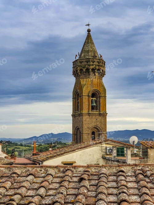 Preview: Vertical shot of bell tower in Peccioli, Tuscany under a cloudy sk
