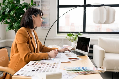 Preview: Confident smiling architect woman working on project in office.