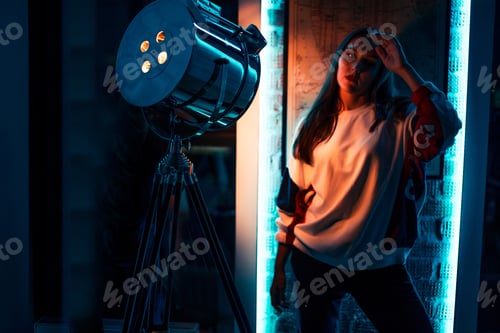 Preview: young beautiful model in fashion casual outfit preparing for the photo session