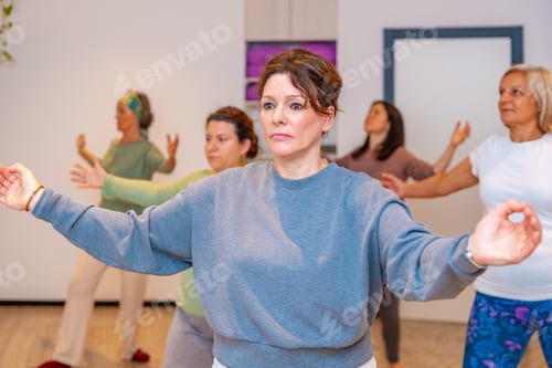 Preview: Women opening arms during qi gong class
