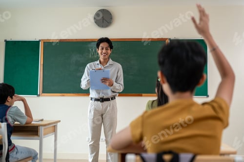 Preview: Asian male teacher educating group of students at elementary school.