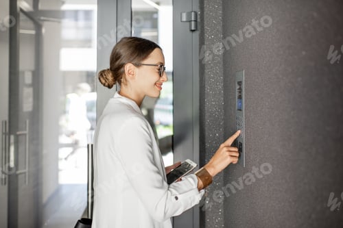 Preview: Woman entering code on the building entrance