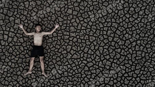 Preview: Boys sleep on dry land with dry and cracked soil, global warming