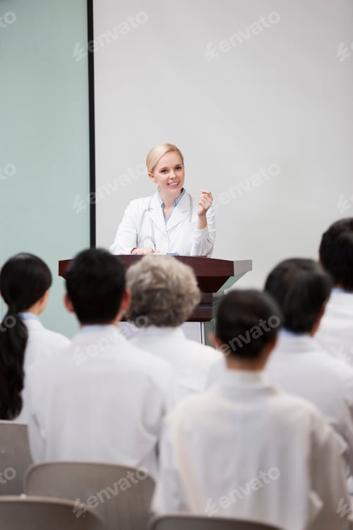 Preview: Female doctor giving speech in boardroom