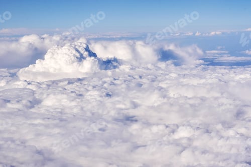 Preview: Aerial view of fluffy clouds in a stratosphere from airplane window