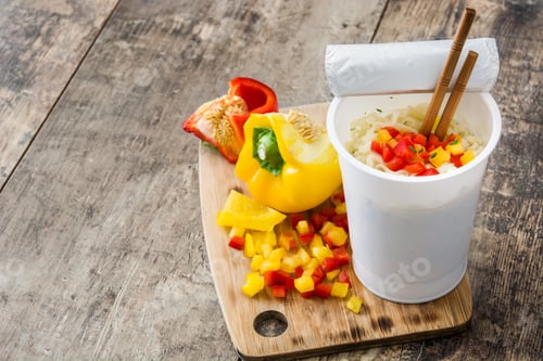 Preview: Instant noodles with chopsticks and diced bell peppers on rustic wooden table