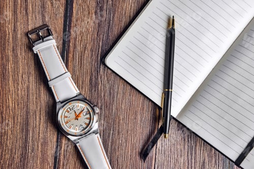 Preview: Top view of open blank notebook with pen and wrist watch on wooden table.
