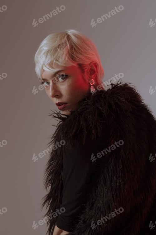 Preview: Beautiful Blonde Girl With Short Hair And Makeup In A Black Fur Coat