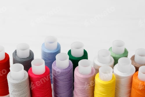 Preview: Close up of colored thread coils, thread spools background