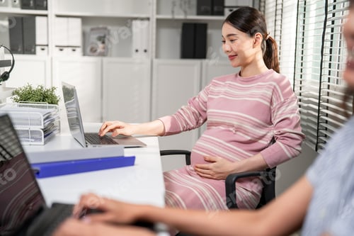 Preview: Asian young pregnant businesswoman working with happiness in the office.