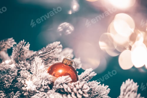 Preview: Christmas decorations with ball and fir branch in magic light.