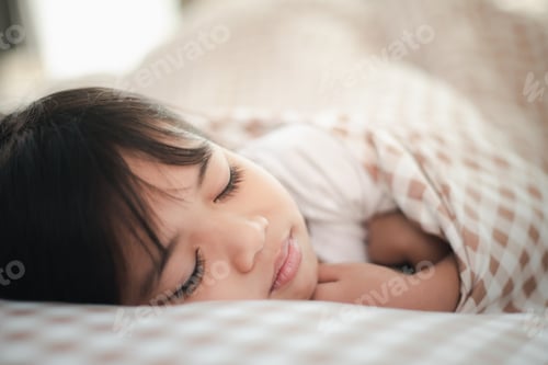 Preview: child little girl sleeps in the bed with a toy teddy bear
