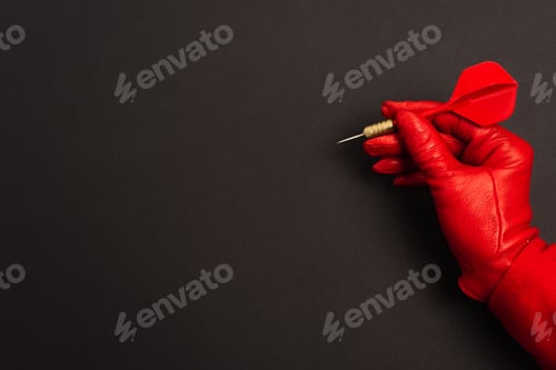Preview: cropped view of woman in red glove holding dart on black