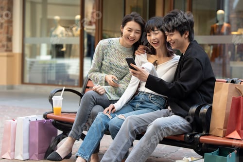 Preview: Happy young Chinese friends shopping together