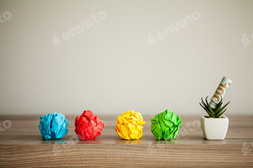 Preview: Great idea concept. Crumpled colorful paper on wooden table