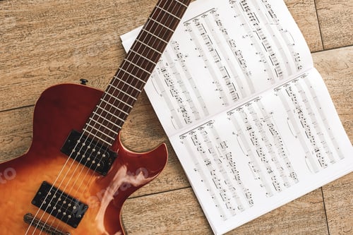 Preview: The sound of rock music. The sound of rock music. Top view of beautiful electric guitar with music