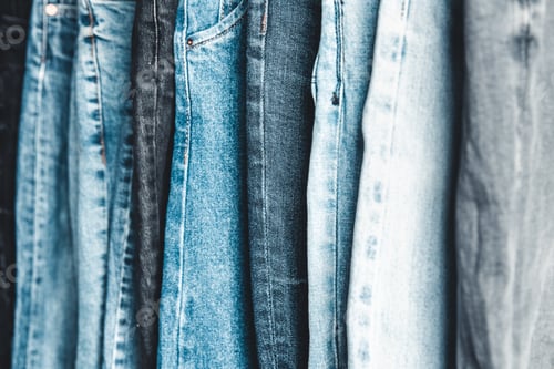 Preview: Rack with different jeans on grey background