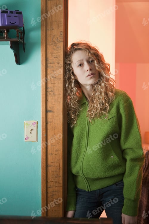 Preview: Teenage girl leaning in doorway, portrait