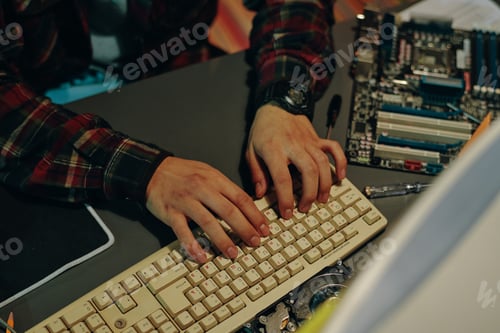 Preview: Programmer typing on keyboard of computer