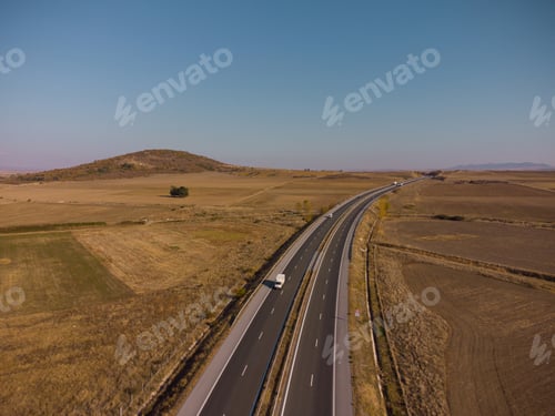Preview: Aerial view of highway road at sunset in autumn. Top view from drone of road