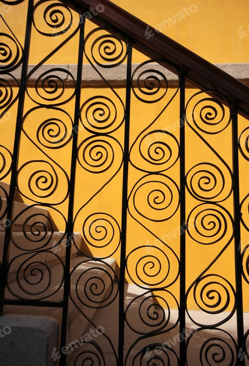 Preview: Architectural Staircase with Decorative Metalwork and Yellow Wall