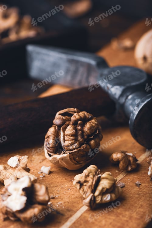 Preview: Cracked walnuts and hammer
