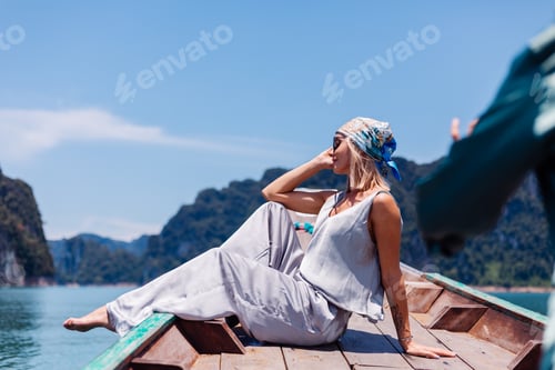 Preview: woman tourist at lake in silk suit on vacation